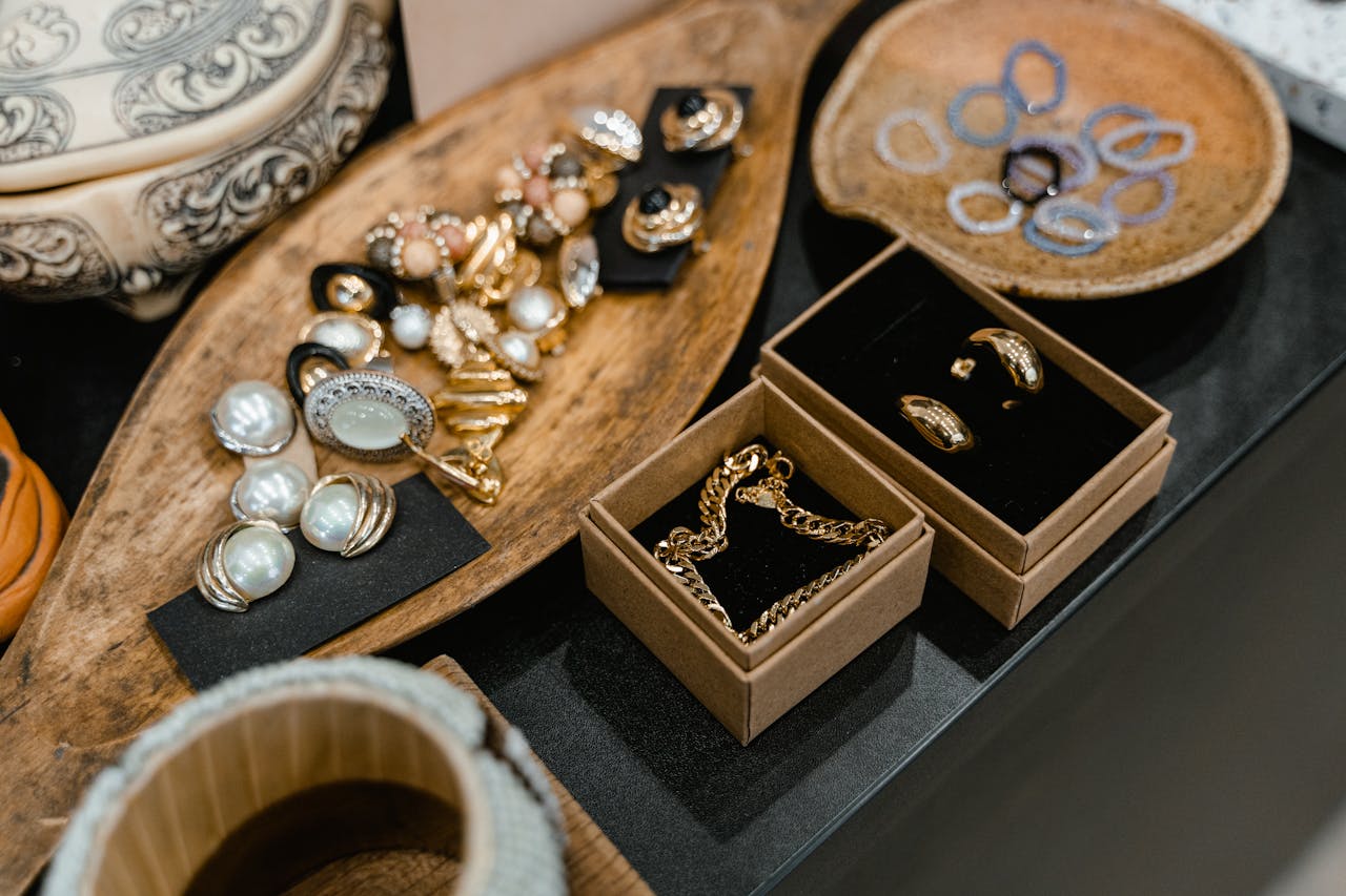 gallery-04 A sophisticated display of assorted jewelry pieces arranged on elegant wooden trays.